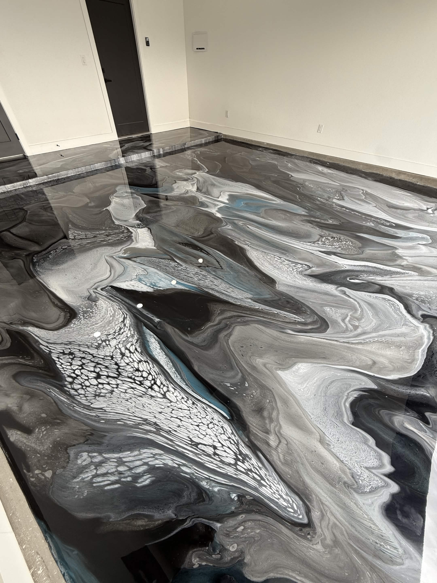 Black and silver metallic epoxy with flowing blue accents